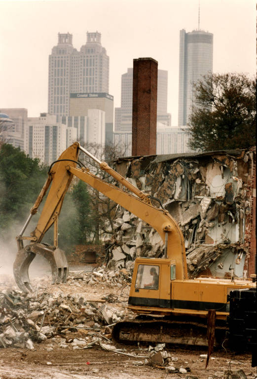 Excavator demolishing Techwood Homes in Atlanta in preparation for the olympic games